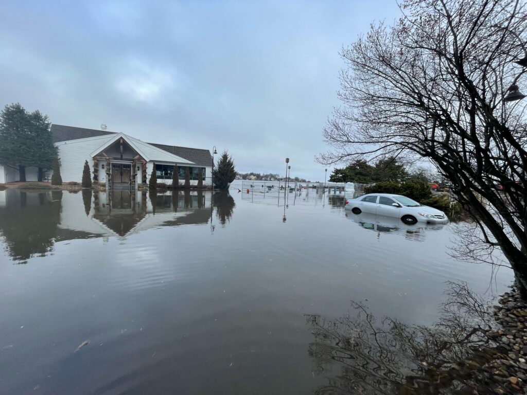 a flooded street with a car parked on the side (MyCoast AI)