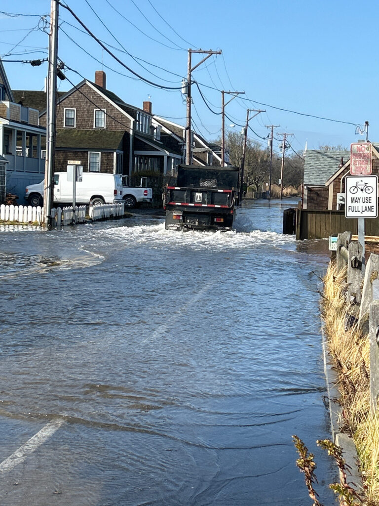 a truck driving through a flooded street (MyCoast AI)