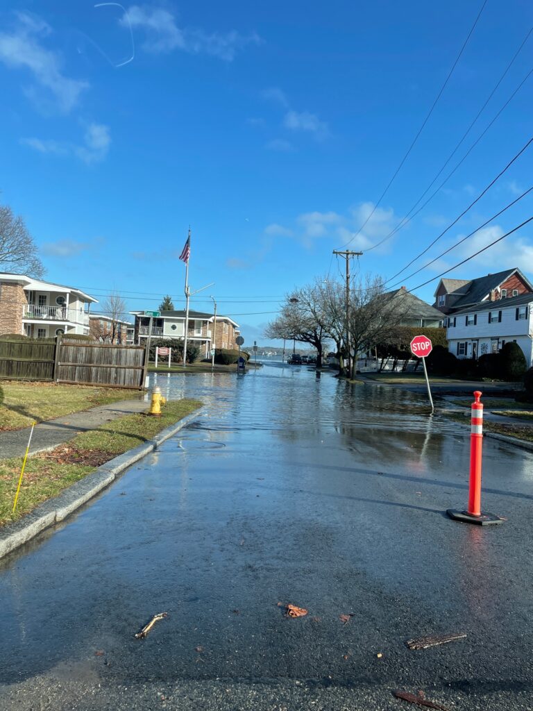 a wet street with a stop sign (MyCoast AI)