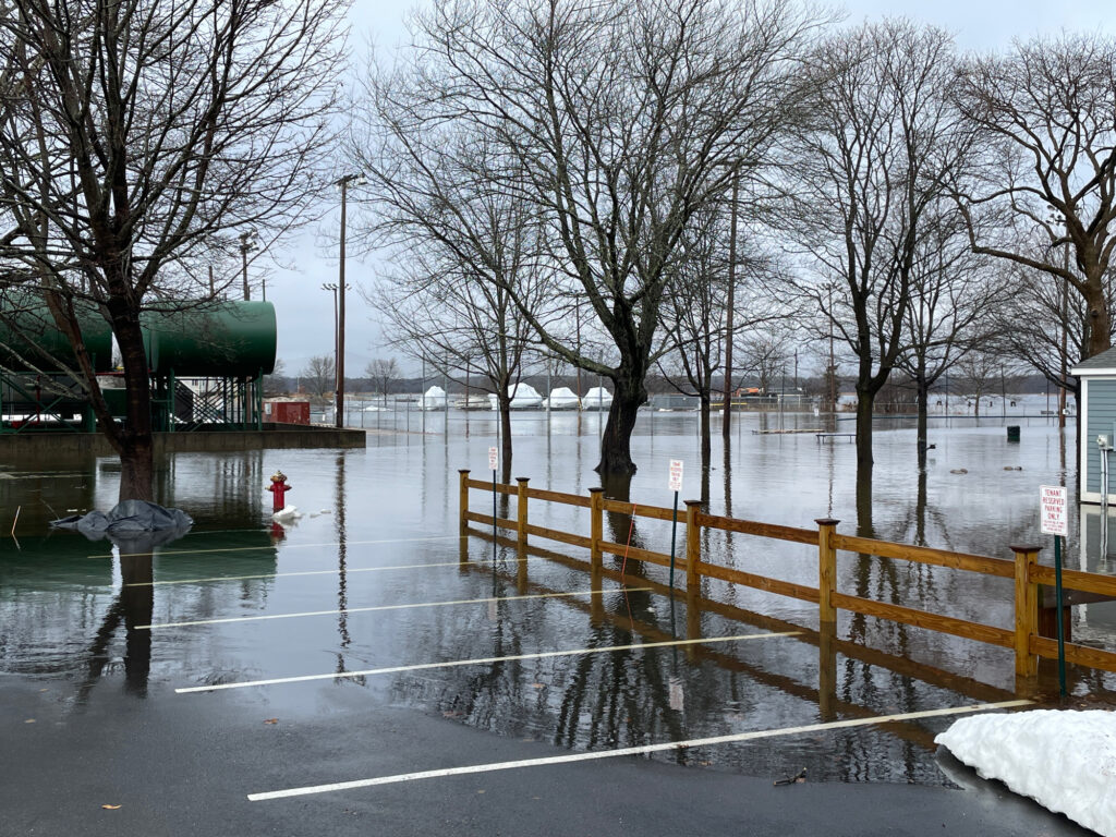 a flooded area with a fence and trees (MyCoast AI)