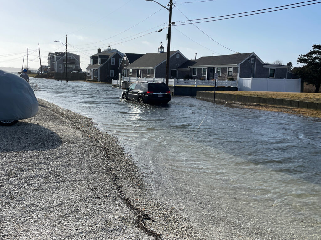 a flooded street with a car parked on the side (MyCoast AI)