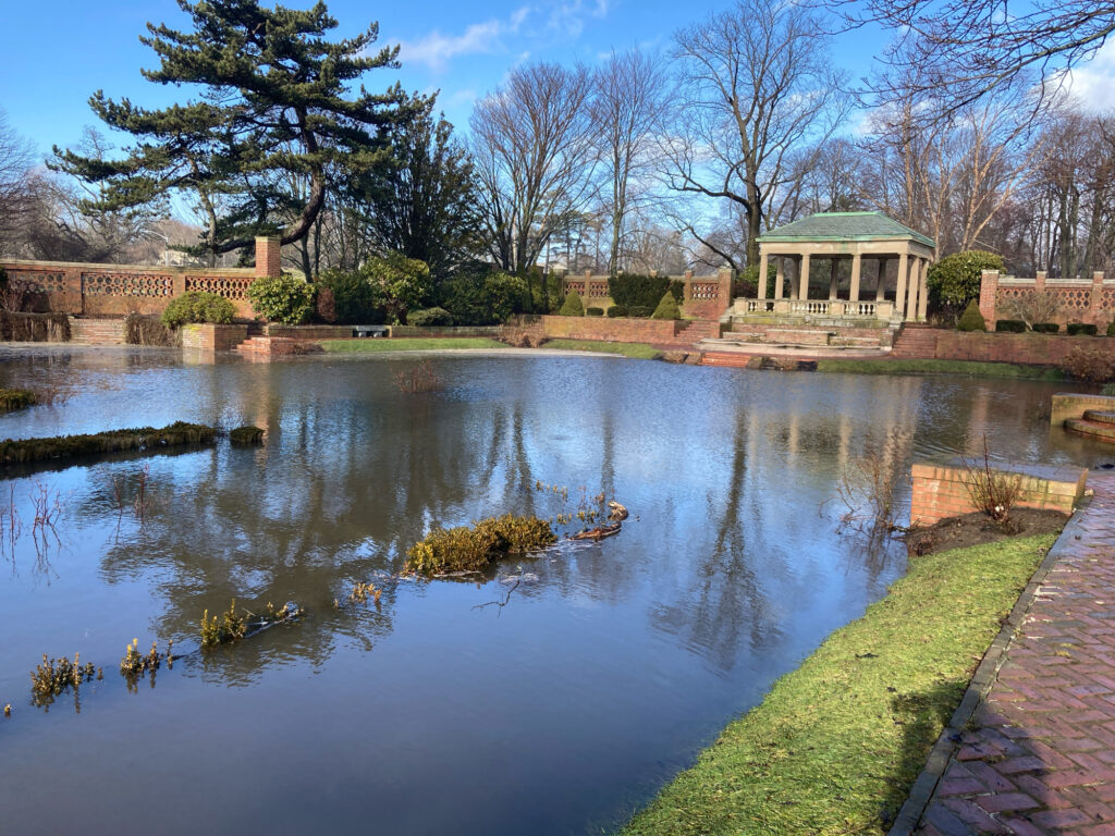a pond with a house in the background (MyCoast AI)