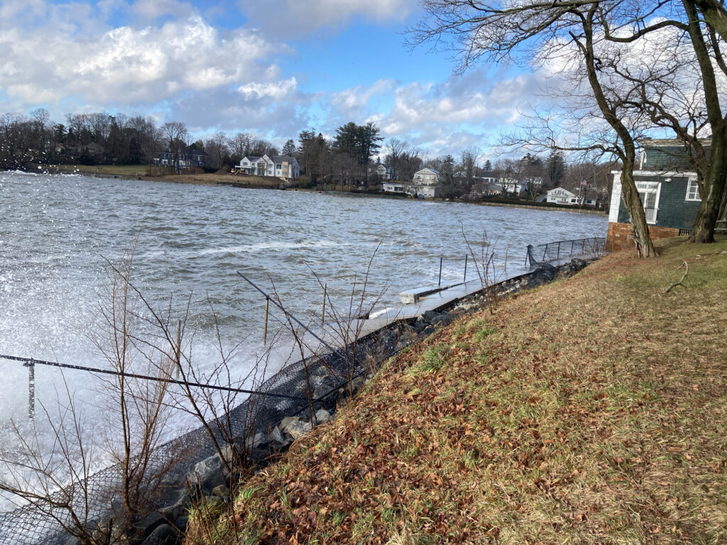 a body of water with a fence and trees around it (MyCoast AI)
