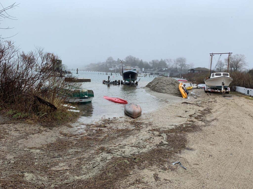 a muddy area with boats and a crane (MyCoast AI)
