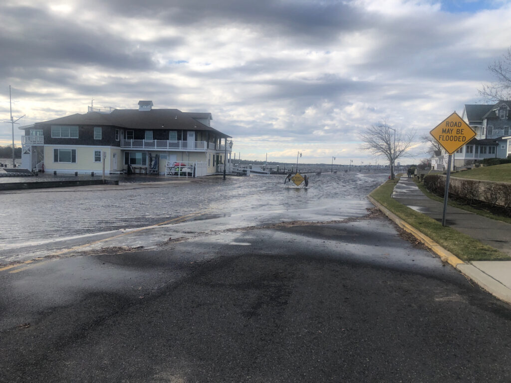 a flooded street with a boat (MyCoast AI)