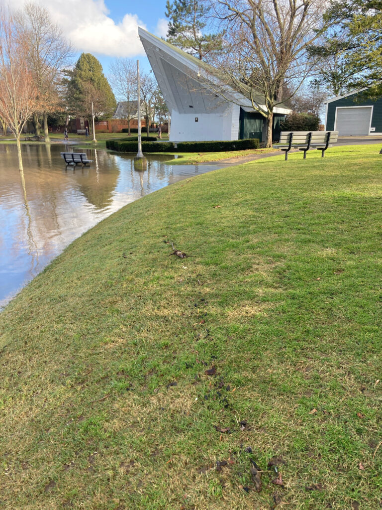 a white building next to a pond (MyCoast AI)