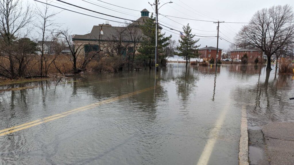a flooded street with houses and trees (MyCoast AI)