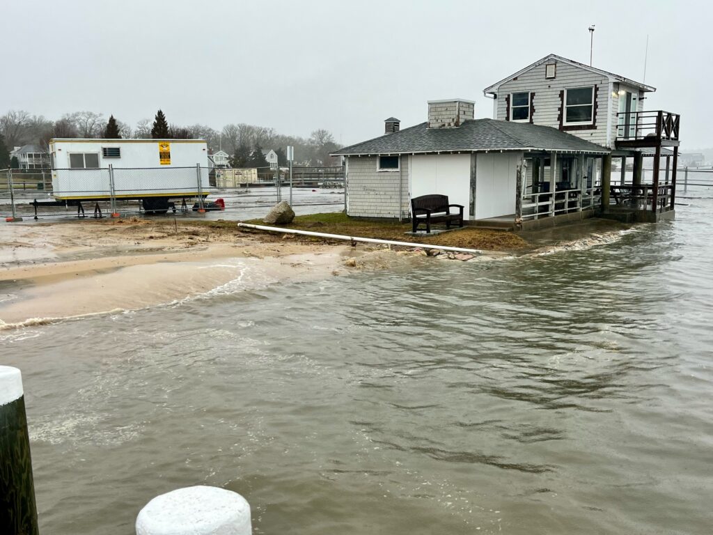 a flooded area with a house and a boat in it (MyCoast AI)