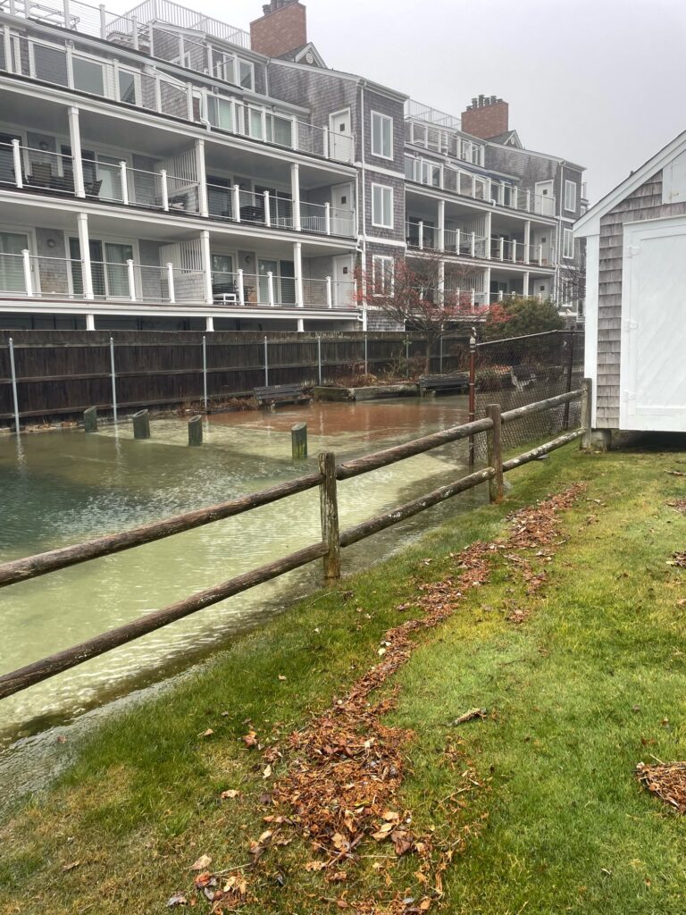 a building with a fence and a river in front of it (MyCoast AI)