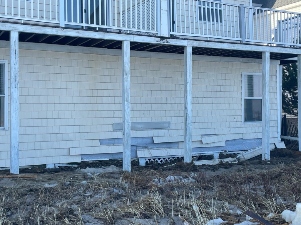 a white building with a fence (MyCoast AI)