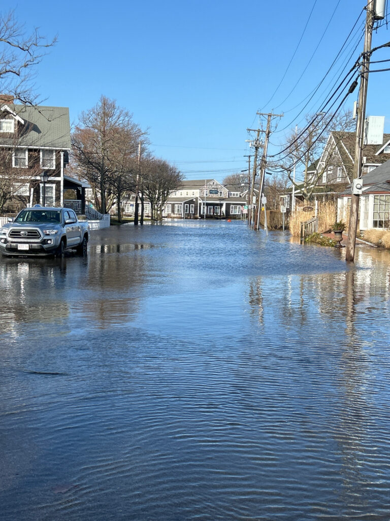 a flooded street with a truck parked on the side (MyCoast AI)