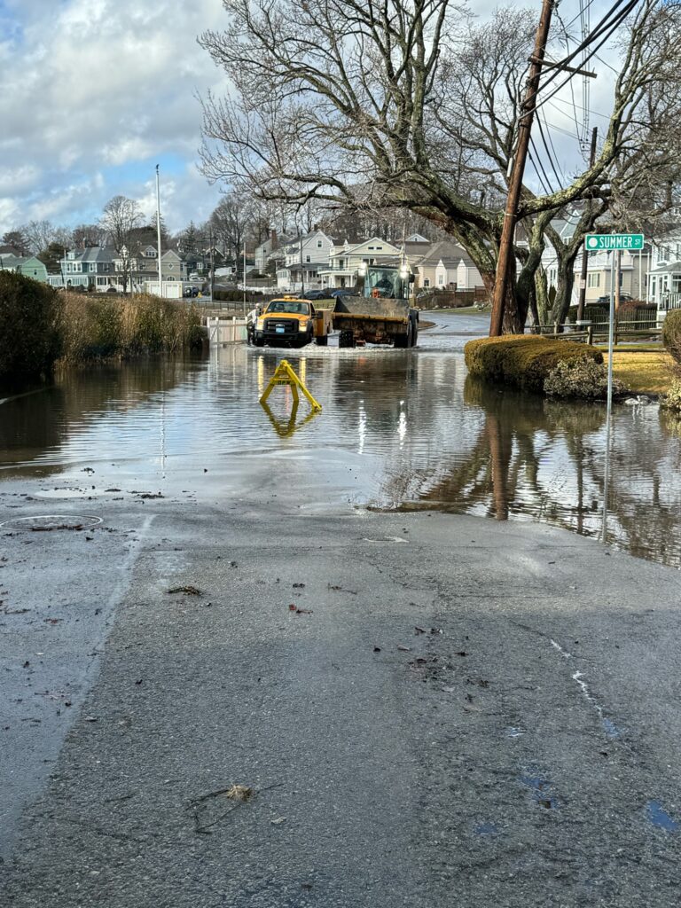 a flooded street with a truck and a tractor (MyCoast AI)
