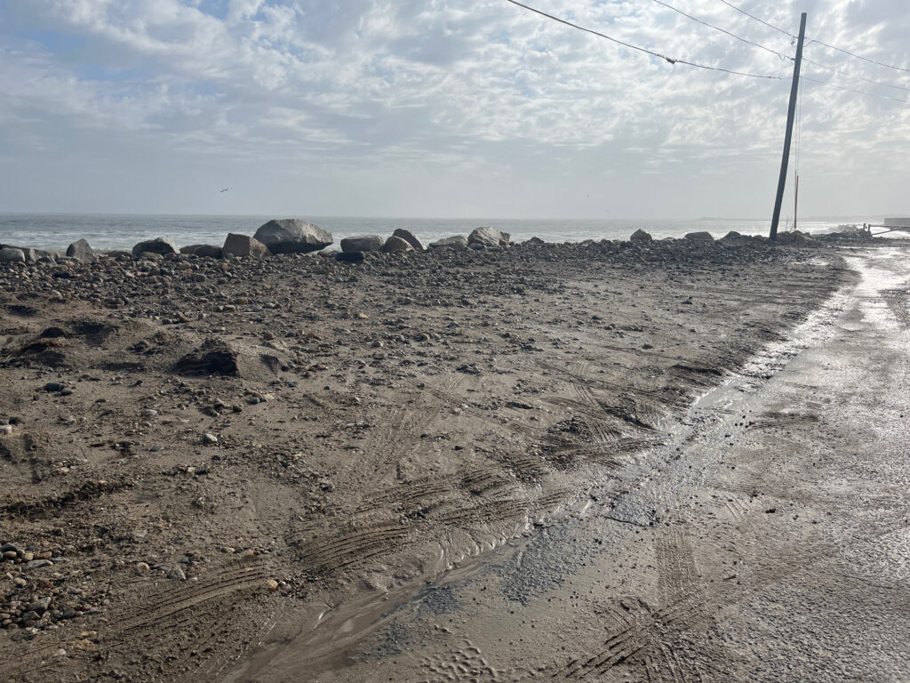 a rocky area with a pole in the distance (MyCoast AI)
