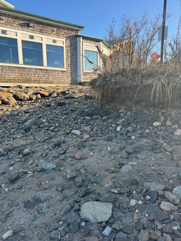 a rocky area with a building in the background (MyCoast AI)