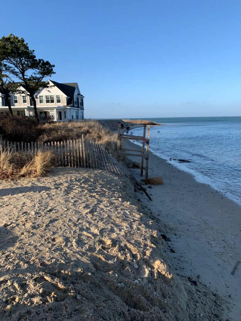 a beach with a house and a fence (MyCoast AI)