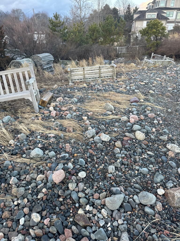 a rocky area with a bench and a fence (MyCoast AI)