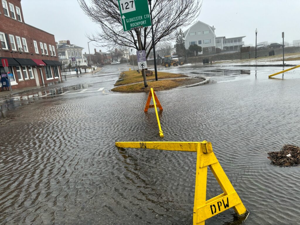 a flooded street with a sign (MyCoast AI)