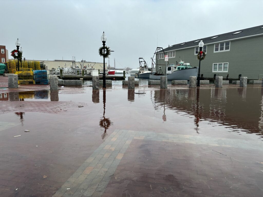 a flooded street with a boat (MyCoast AI)