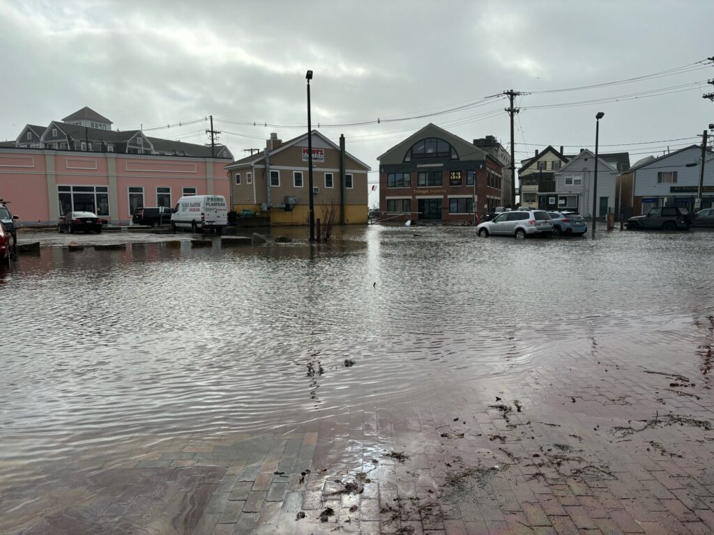 a flooded street with buildings and cars (MyCoast AI)