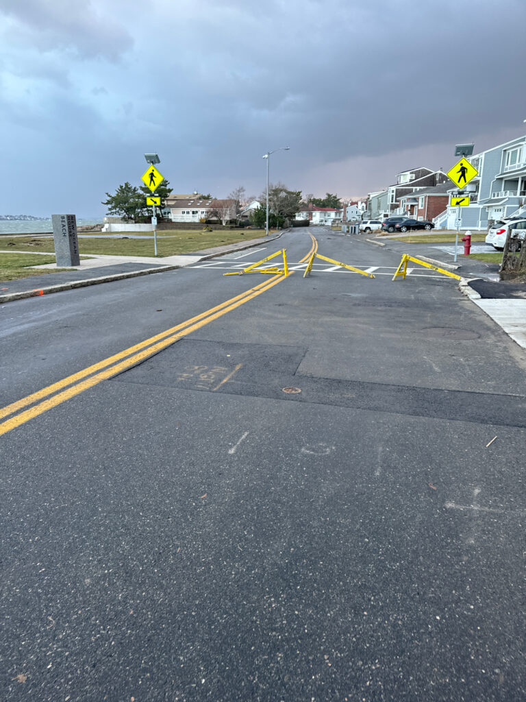 a road with a yellow sign (MyCoast AI)