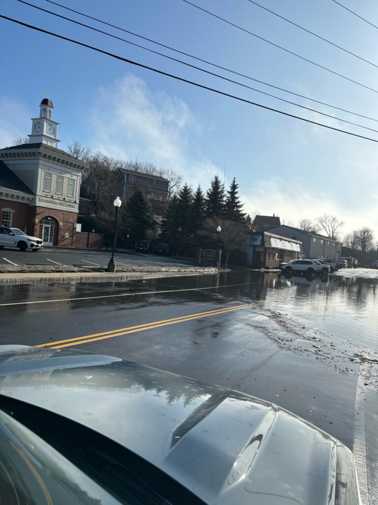 a road with cars on it and buildings on the side (MyCoast AI)