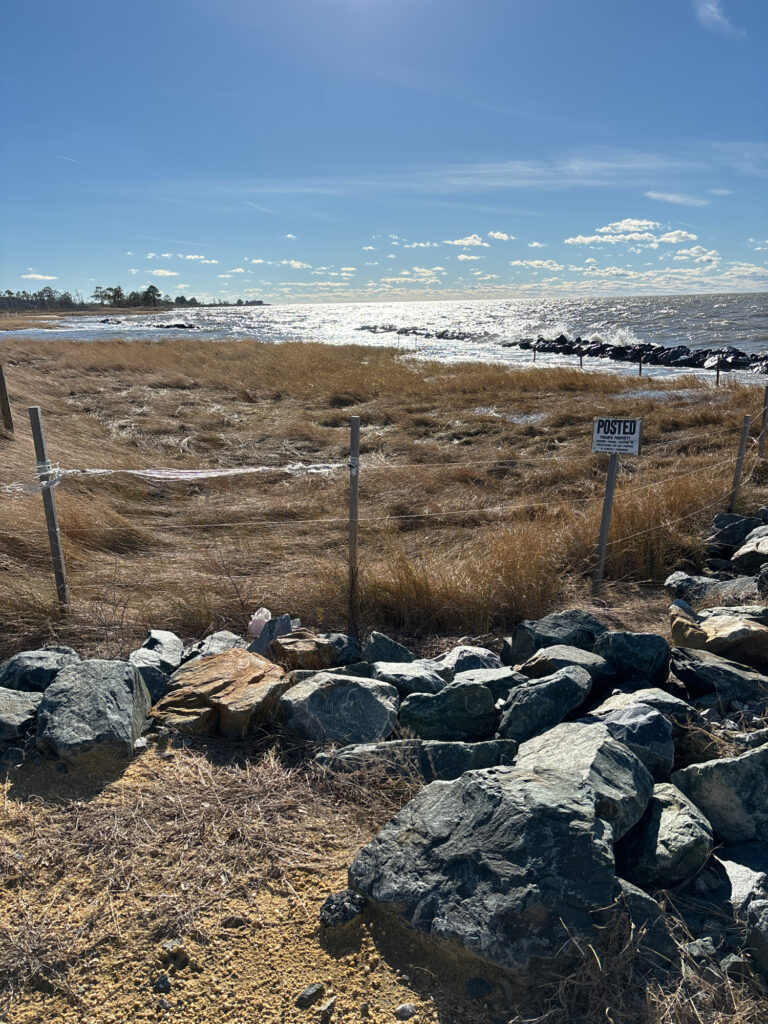 a rocky beach with a fence (MyCoast AI)