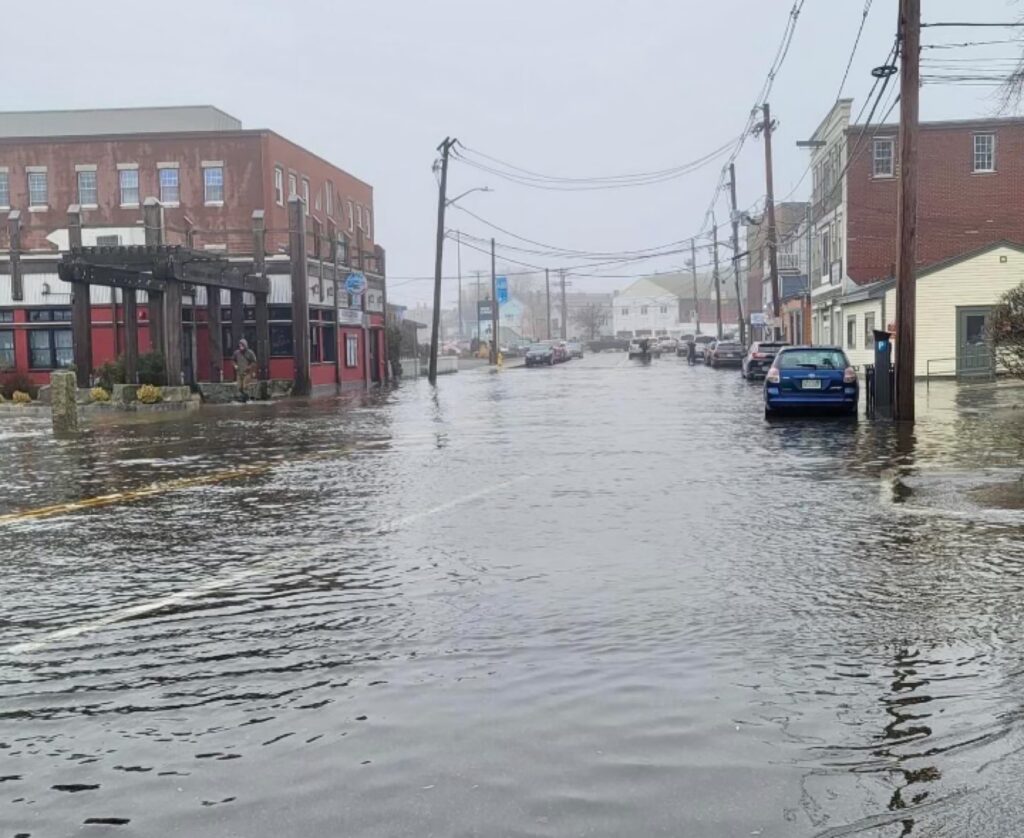 a flooded street with cars and buildings (MyCoast AI)