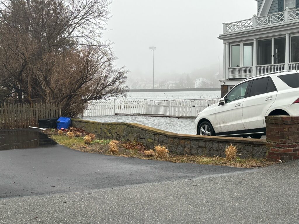 a white car parked on the side of a road (MyCoast AI)