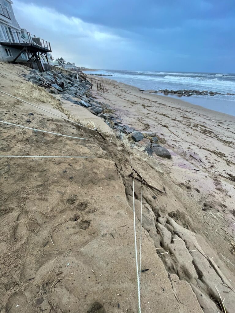 a sandy beach with a bridge (MyCoast AI)