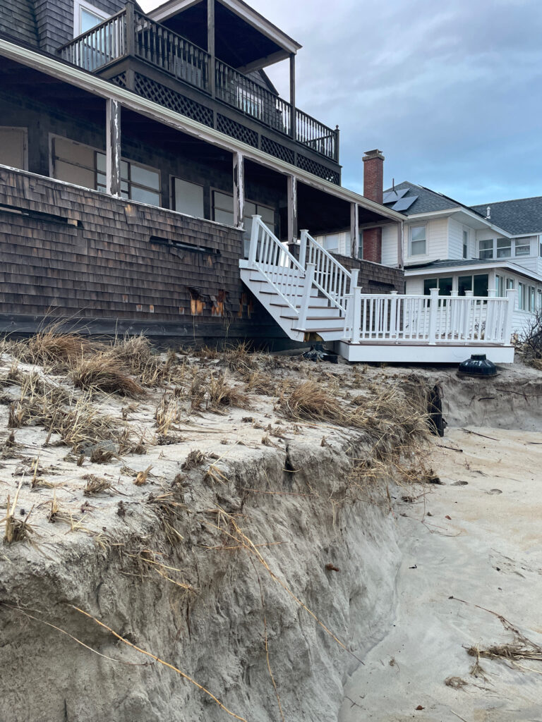 a house with a deck and a pile of sand in front of it (MyCoast AI)