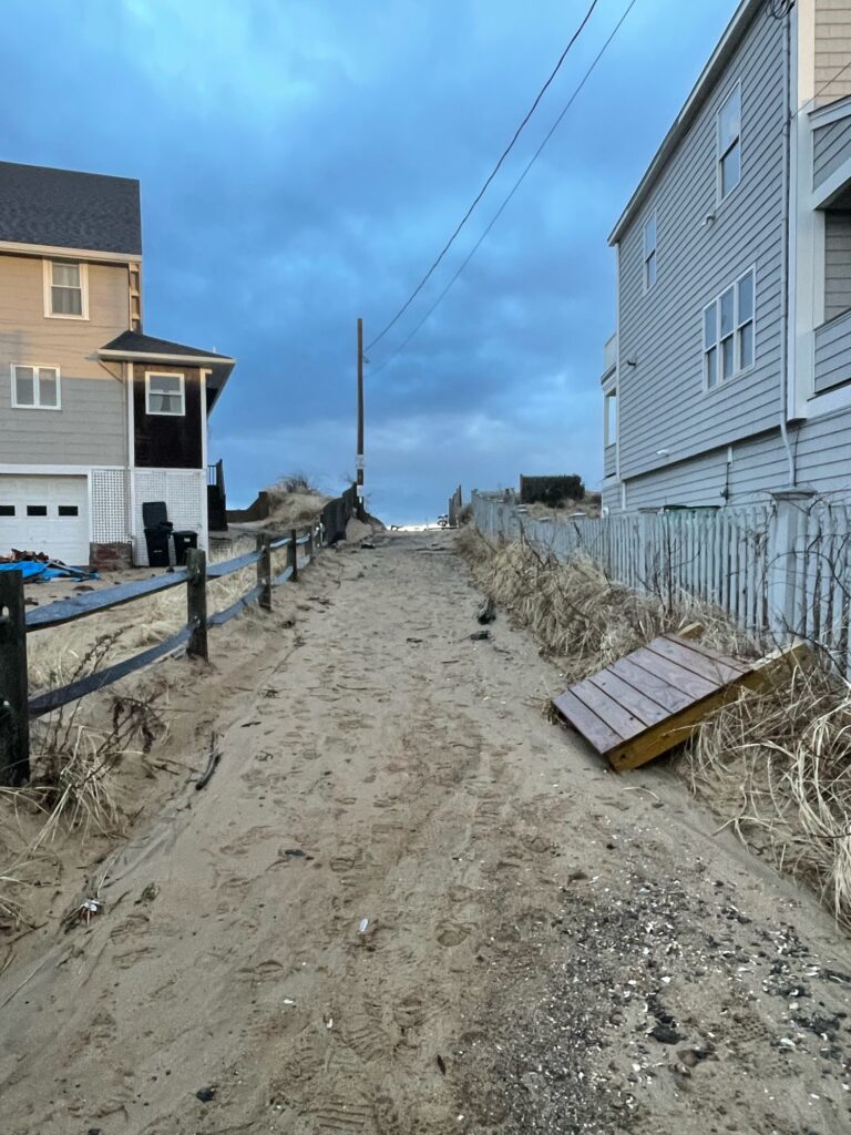 a dirt road between houses (MyCoast AI)