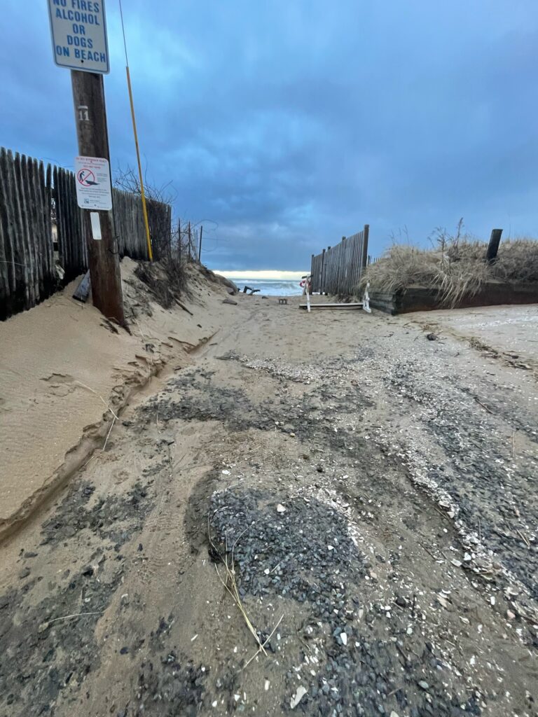 a sandy beach with a sign (MyCoast AI)