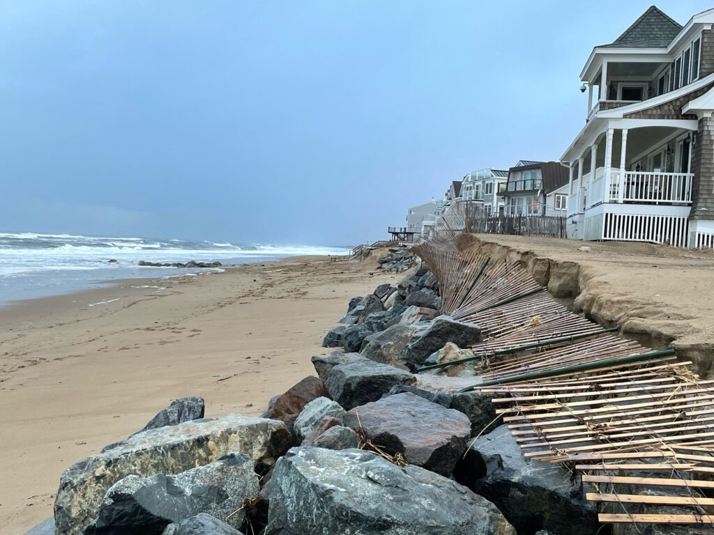 a beach with rocks and a building (MyCoast AI)