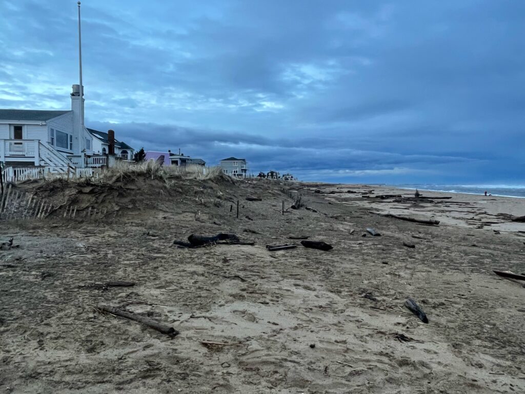 a sandy beach with a building in the background (MyCoast AI)