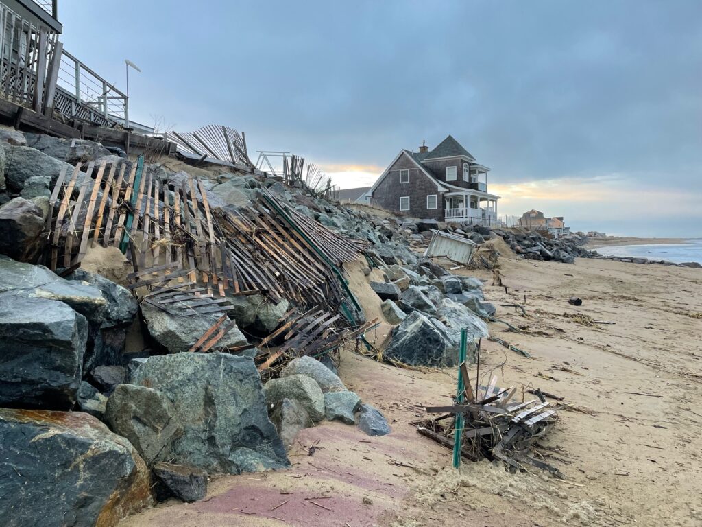 a beach with rocks and a house (MyCoast AI)
