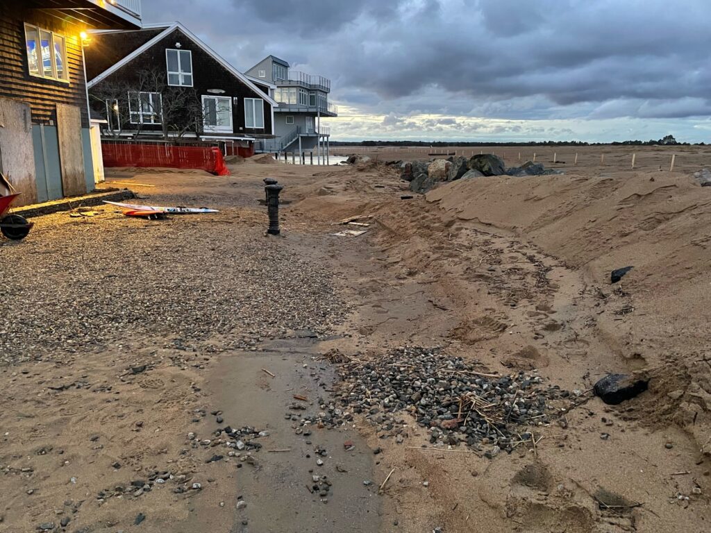a sandy beach with houses on the side (MyCoast AI)