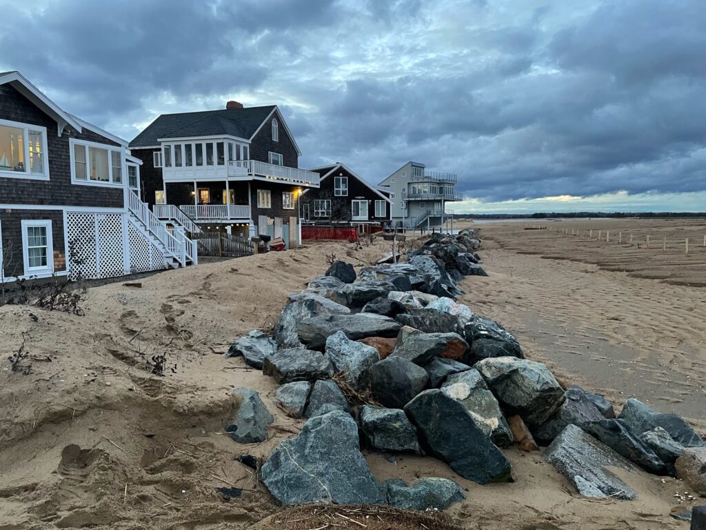 a rocky beach with houses on the side (MyCoast AI)