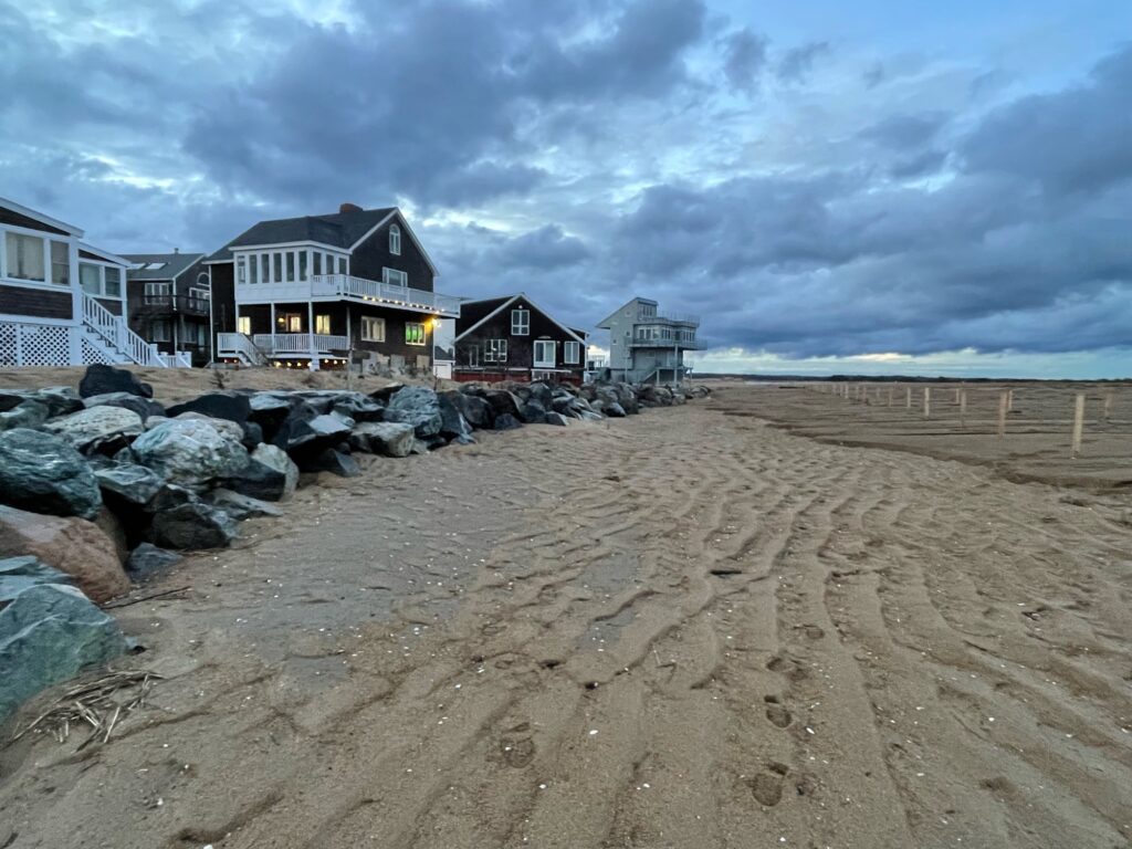 a sandy beach with houses on the side (MyCoast AI)