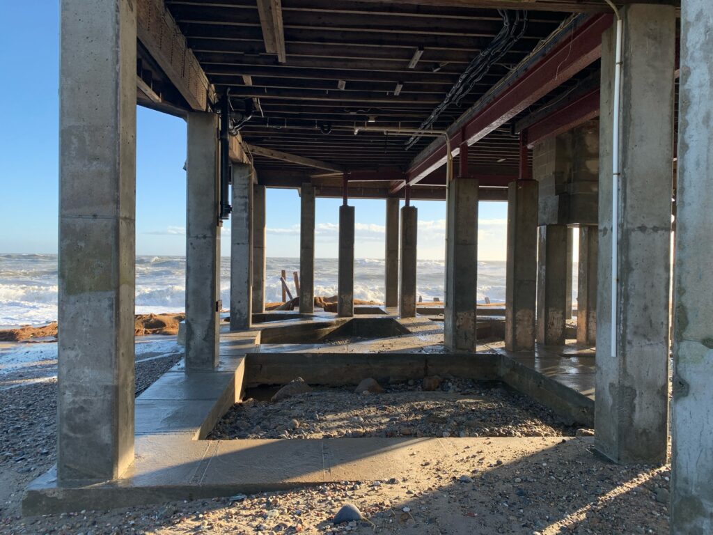 a person standing under a wooden structure (MyCoast AI)