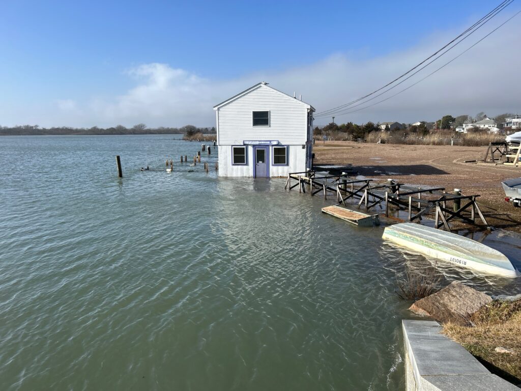 a small white building on a beach (MyCoast AI)