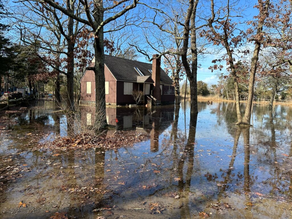 a flooded area with a house in the background (MyCoast AI)