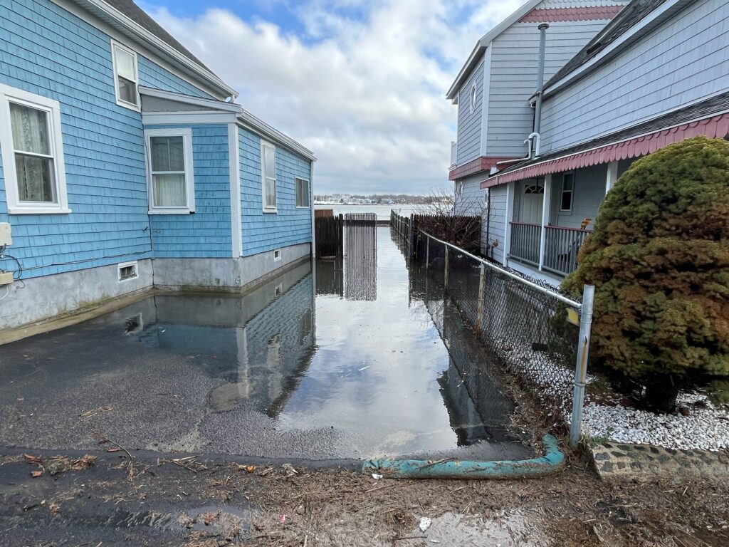 a flooded street between houses (MyCoast AI)
