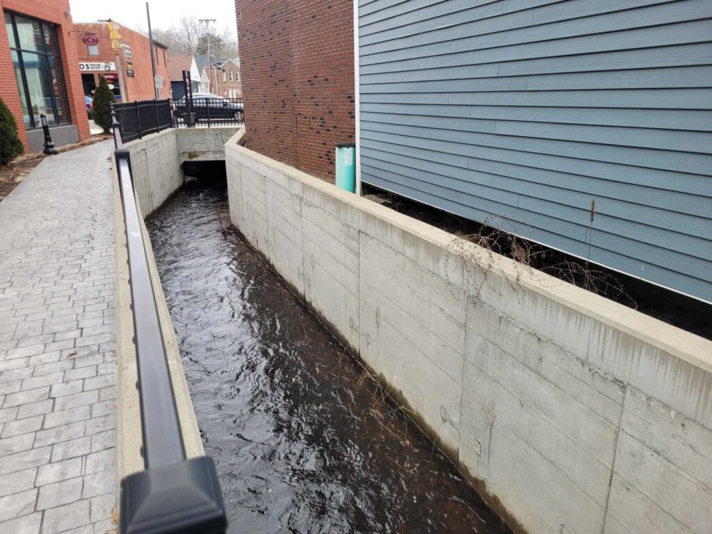 a canal with a brick wall and a brick wall (MyCoast AI)