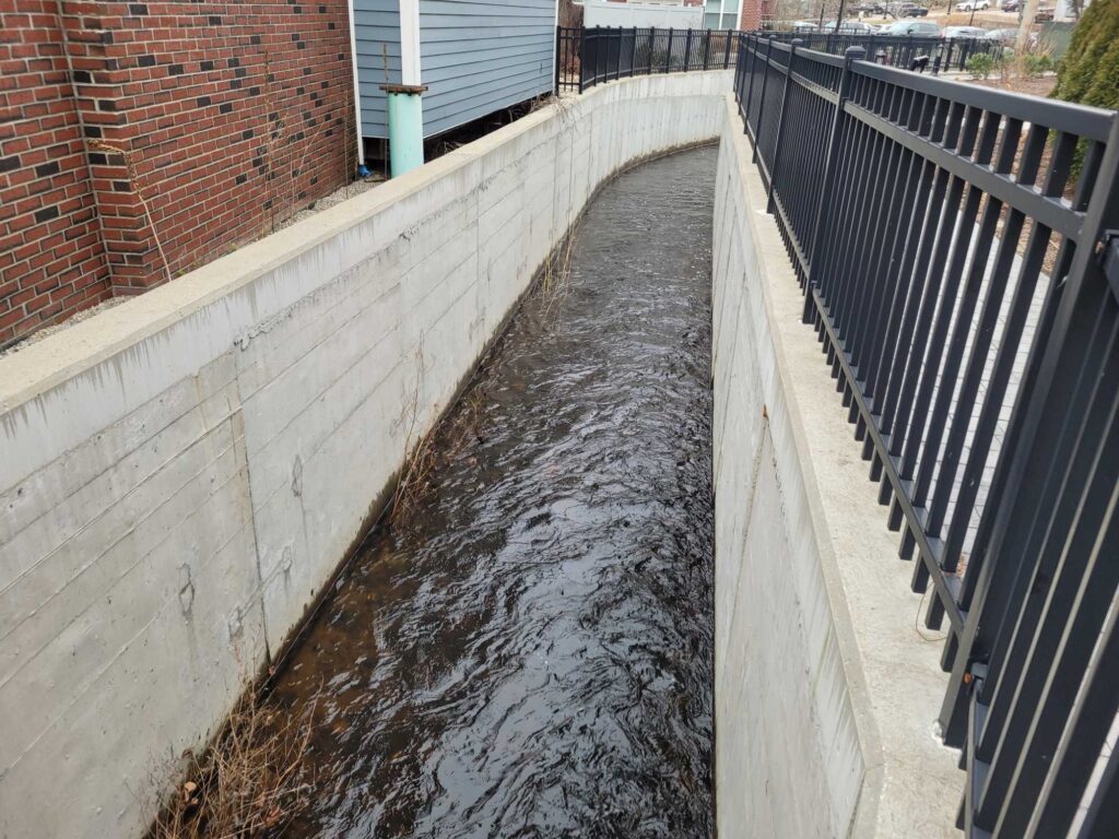 a canal with a brick wall (MyCoast AI)