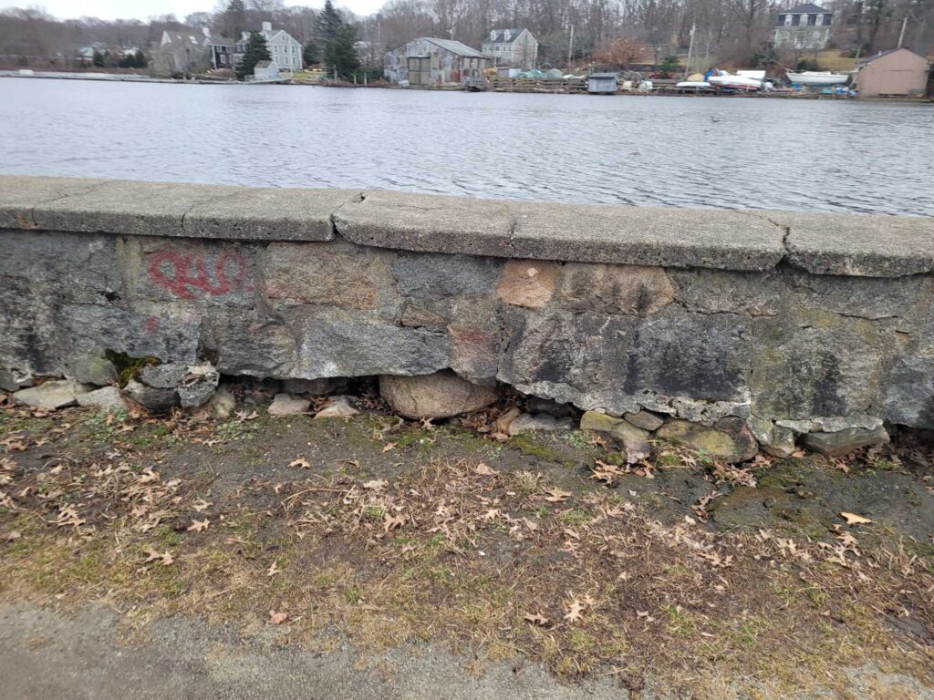 a concrete wall next to a body of water (MyCoast AI)