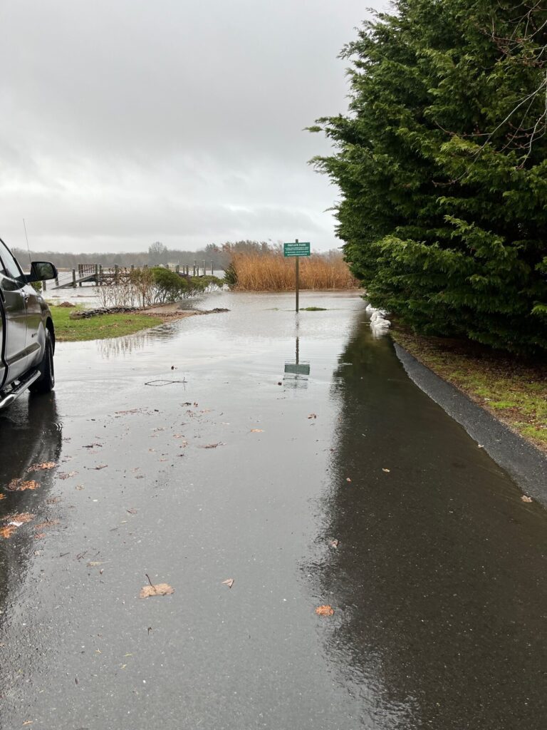 a flooded street with a car parked on the side (MyCoast AI)