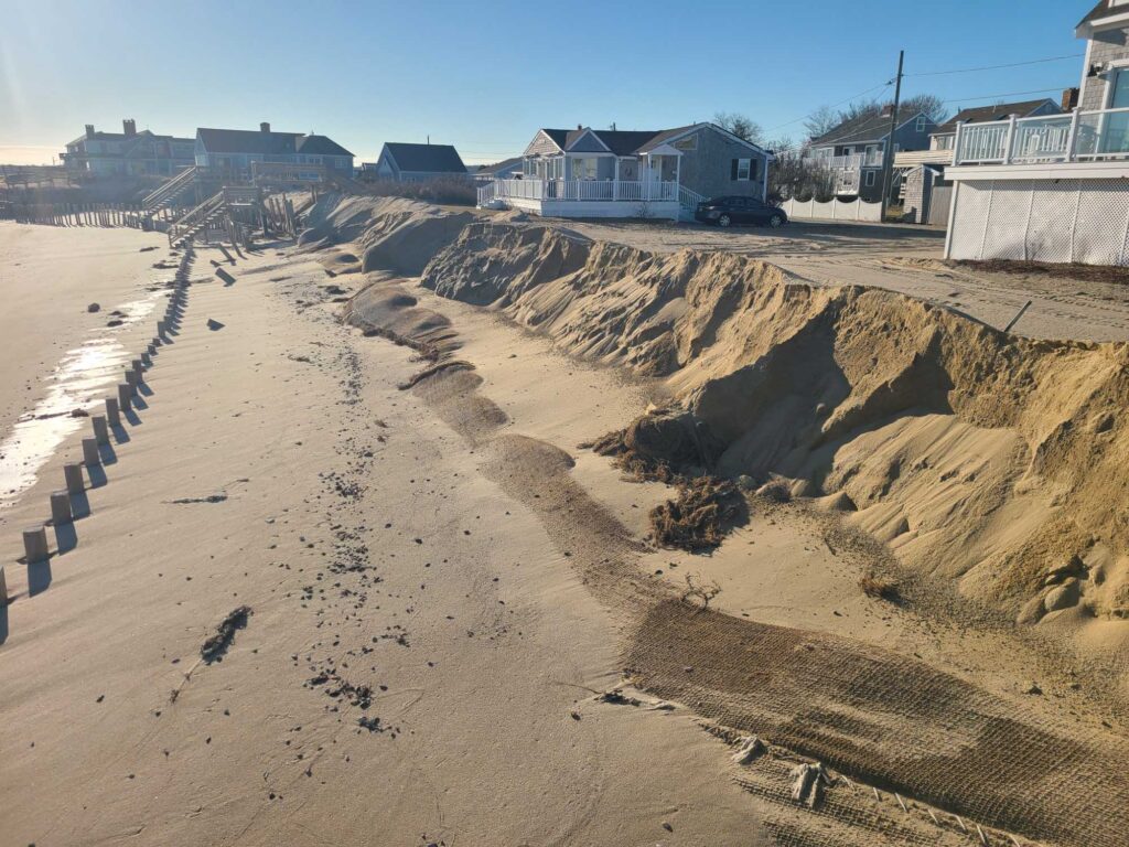 a sandy beach with houses on the side (MyCoast AI)