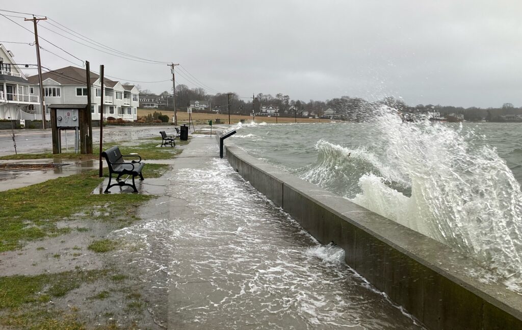 a large wave crashing into a sidewalk (MyCoast AI)