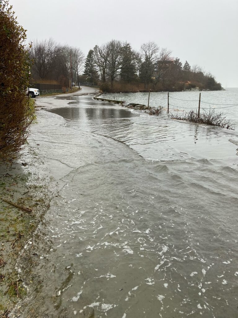 a frozen pond with trees and a car in the background (MyCoast AI)