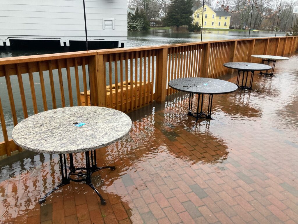 a group of tables on a brick patio (MyCoast AI)